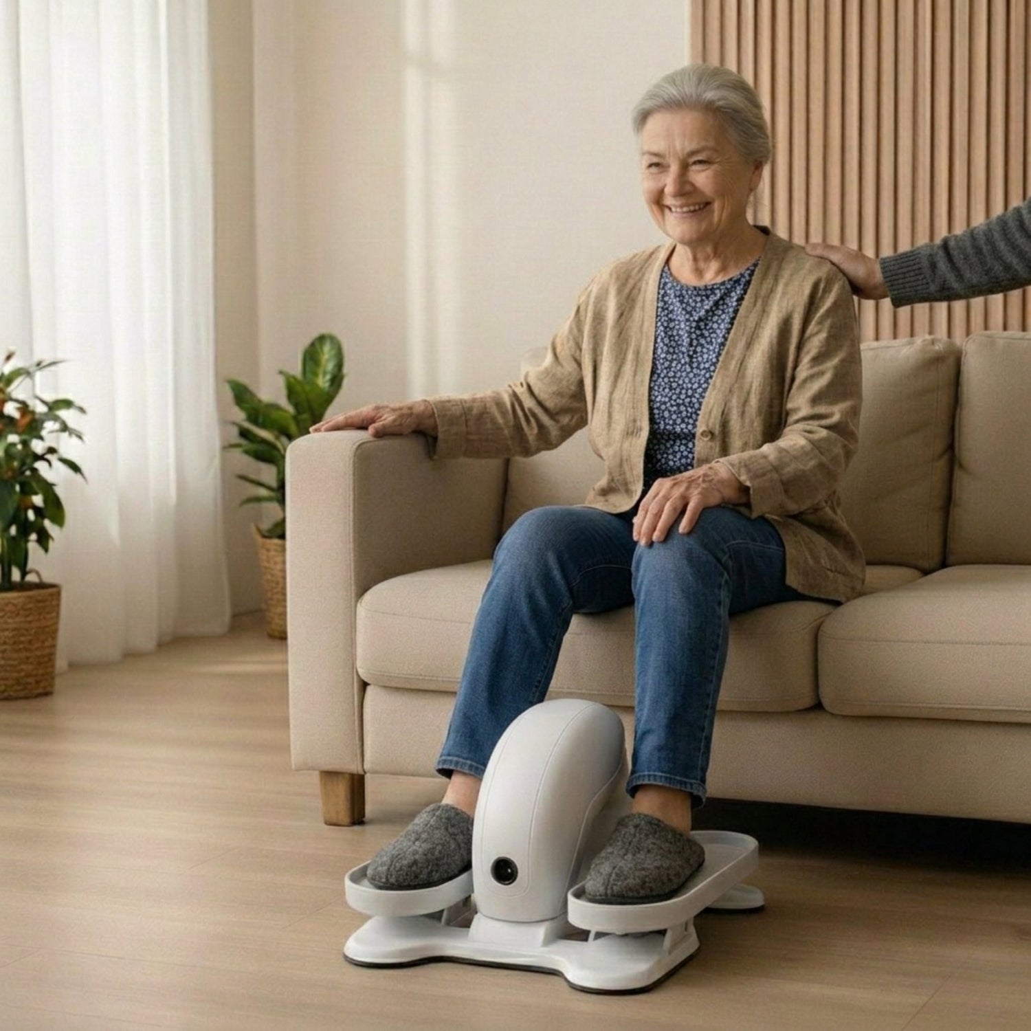 Elderly person using a seated elliptical exerciser at home for passive leg exercise and circulation.